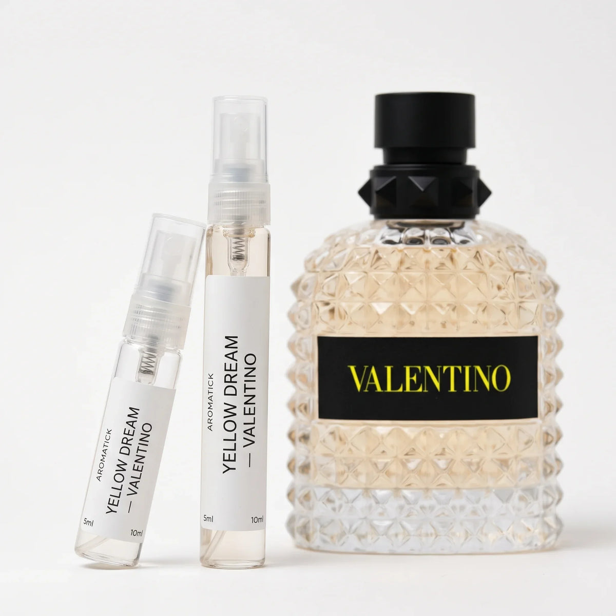 Valentino Born in Roma Yellow Dream decant 5ml and 10ml atomizers beside the yellow studded bottle