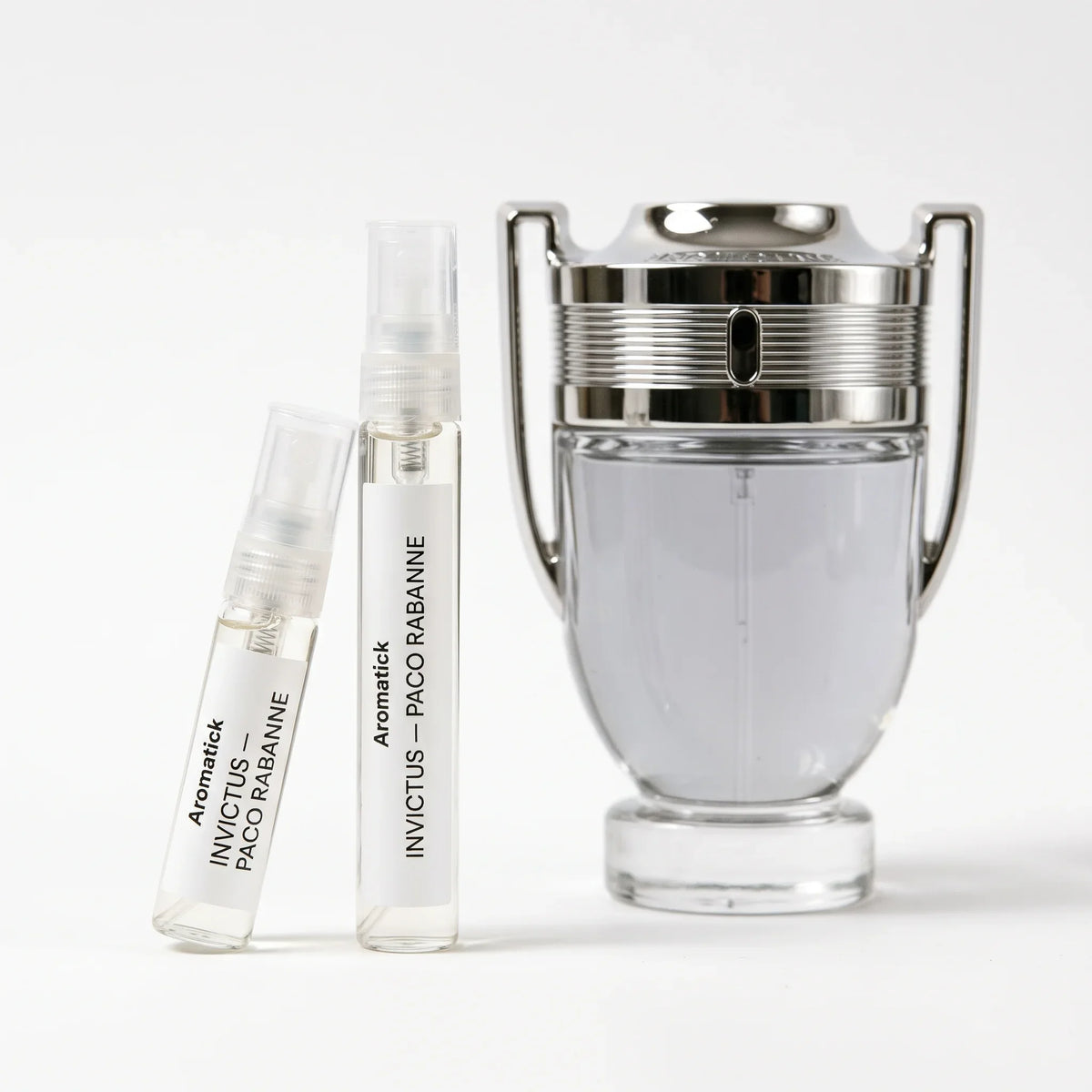 Paco Rabanne Invictus EDT decant 5ml and 10ml atomizers beside the chrome trophy bottle