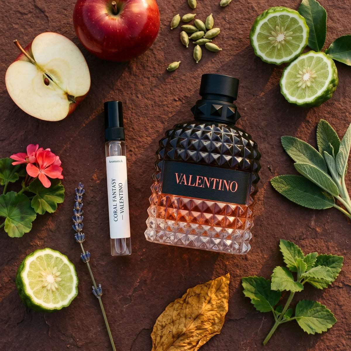 Valentino Coral Fantasy flatlay with red apple, cardamom, geranium, lavender, sage and tobacco leaf
