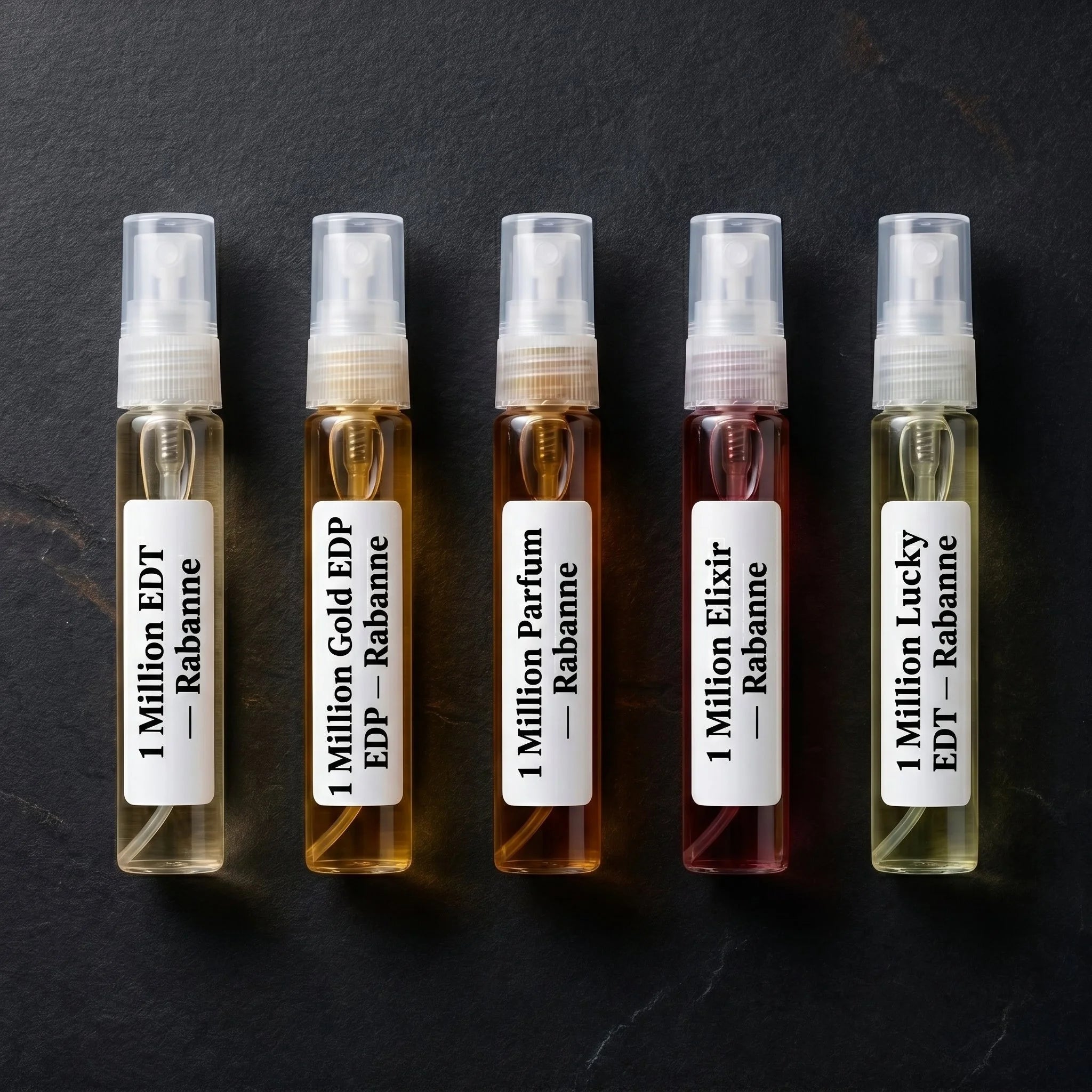 Five Rabanne 1 Million decant vials flatlay on slate — EDT, Gold EDP, Parfum, Elixir, and Lucky