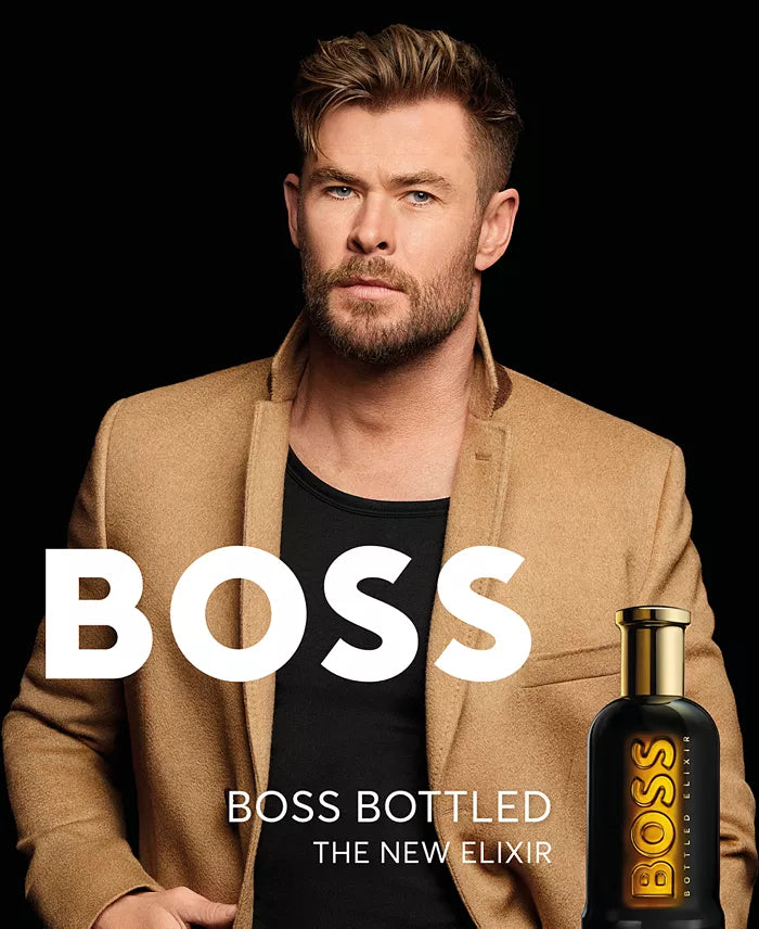 Man in a tan jacket with 'BOSS' branding and a bottle of BOSS bottled on a black background