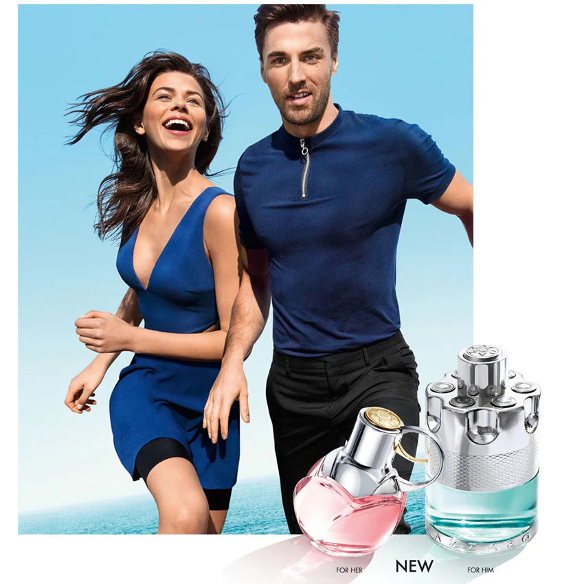 Man and woman running together with two perfume bottles displayed below.
