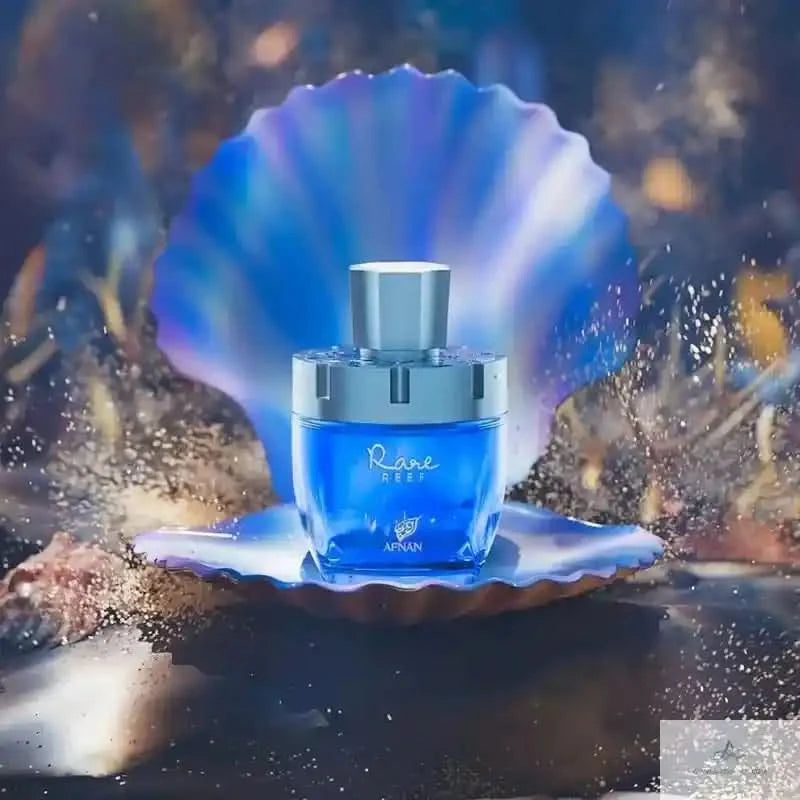 Blue perfume bottle on a seashell with a blurred underwater background