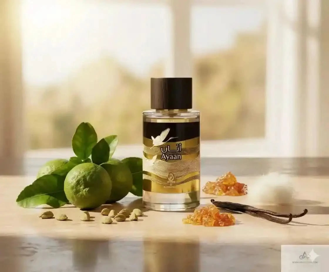 Ayen perfume bottle on a wooden surface with limes, vanilla beans, and flowers.