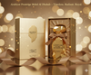 Gold perfume bottle and packaging with 'Arabiyat' branding on a blurred lights background