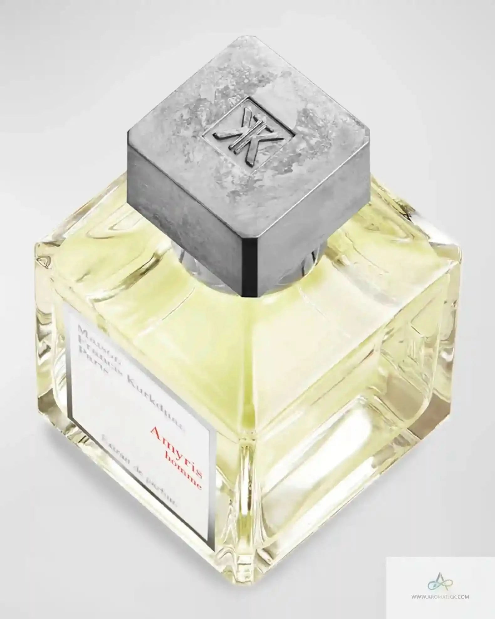 Top view of MFK Amyris Homme bottle with engraved metallic cap, emphasizing the sophisticated design of this men's cologne.