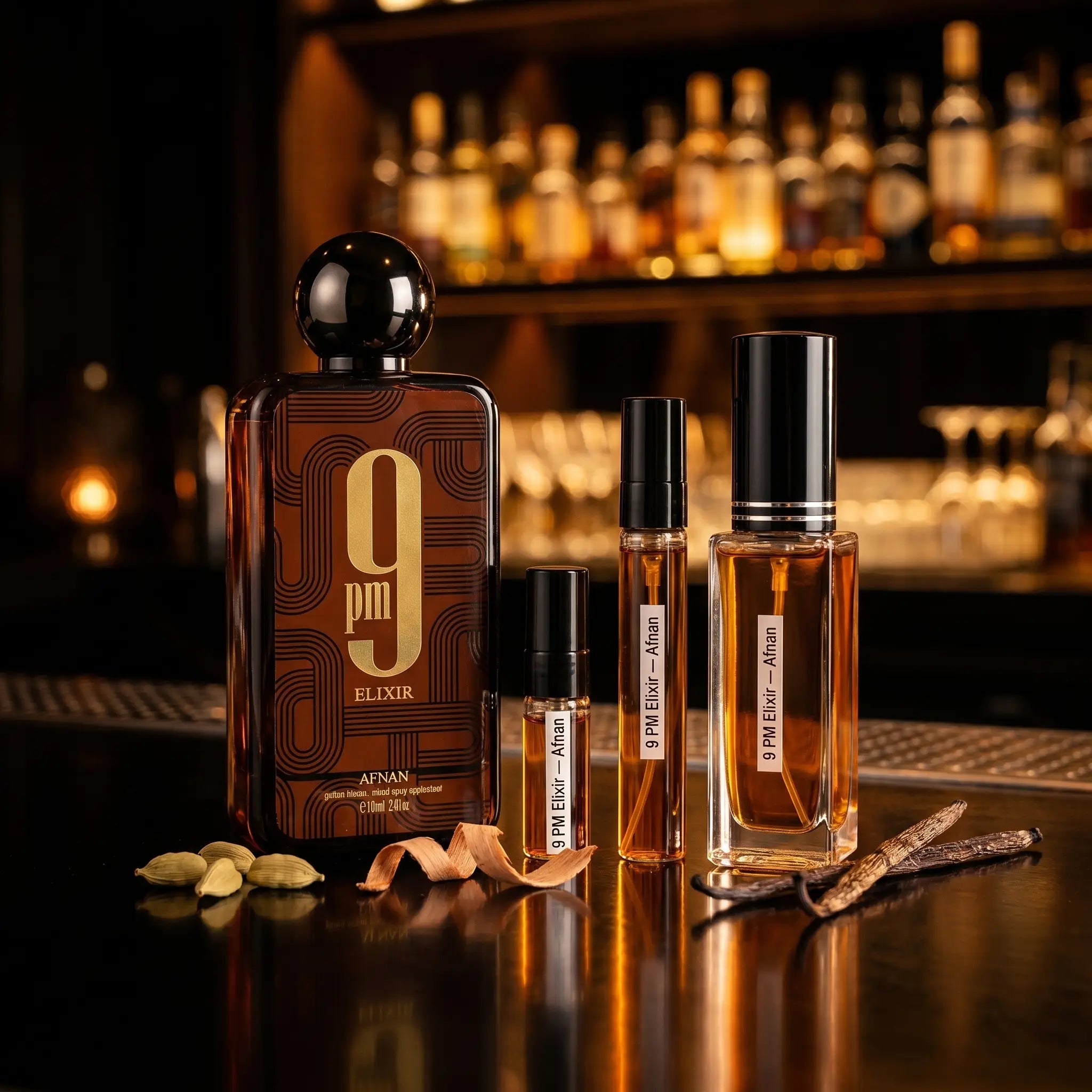 Afnan 9PM Elixir bottle and decants on bar surface with cardamom pods and vanilla pods in amber light