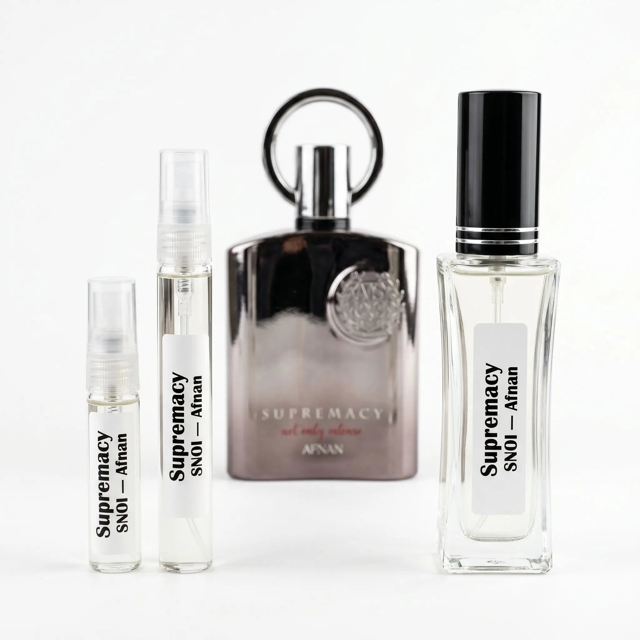 Afnan Supremacy Not Only Intense decants next to full chrome bottle with ring cap on white background