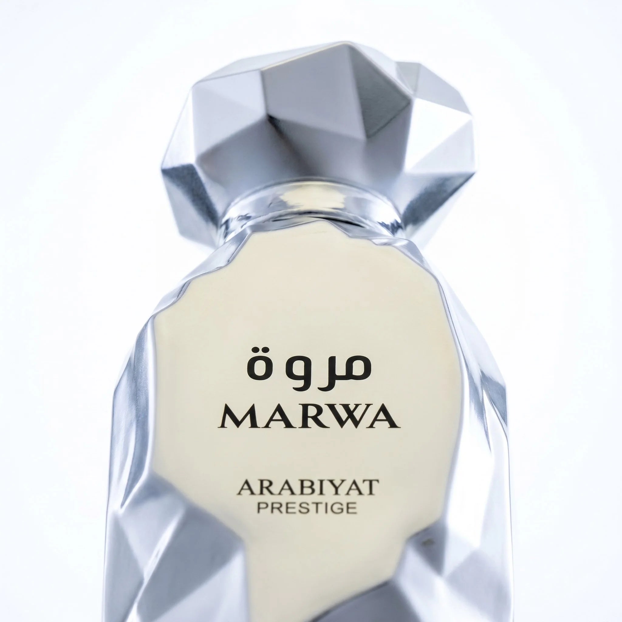 Arabiyat Prestige Marwa silver bottle label closeup showing Arabic script and faceted crystal cap detail