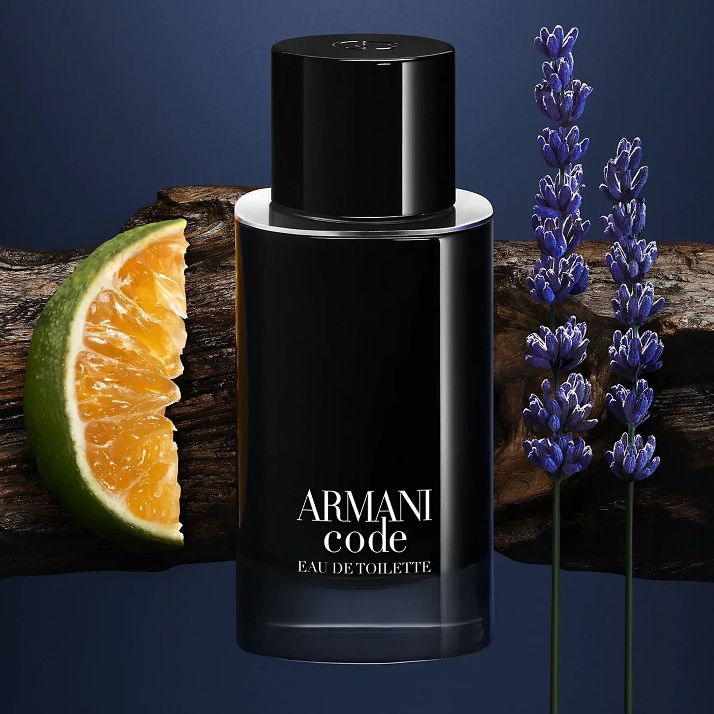 Armani Code perfume bottle with orange slice and lavender on a wooden surface