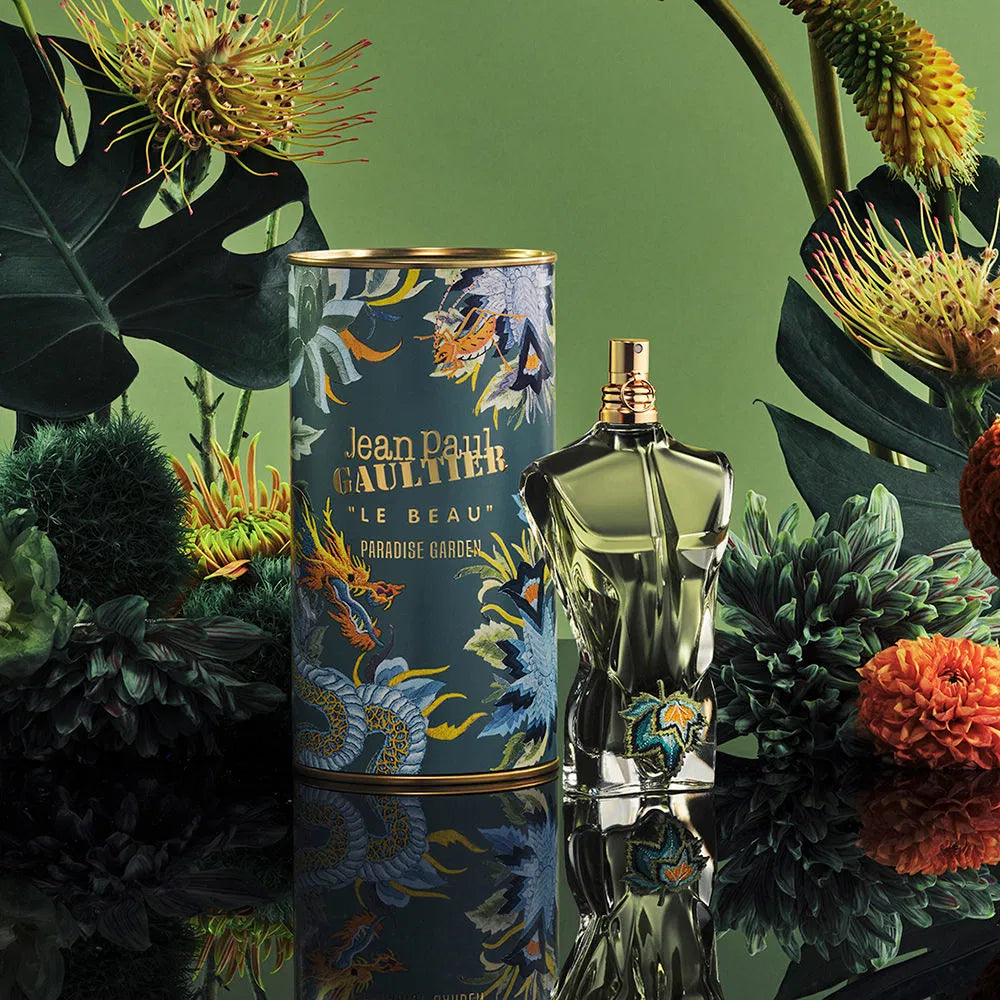 Jean Paul Gaultier perfume bottle and packaging with floral and nature-themed design on a green background