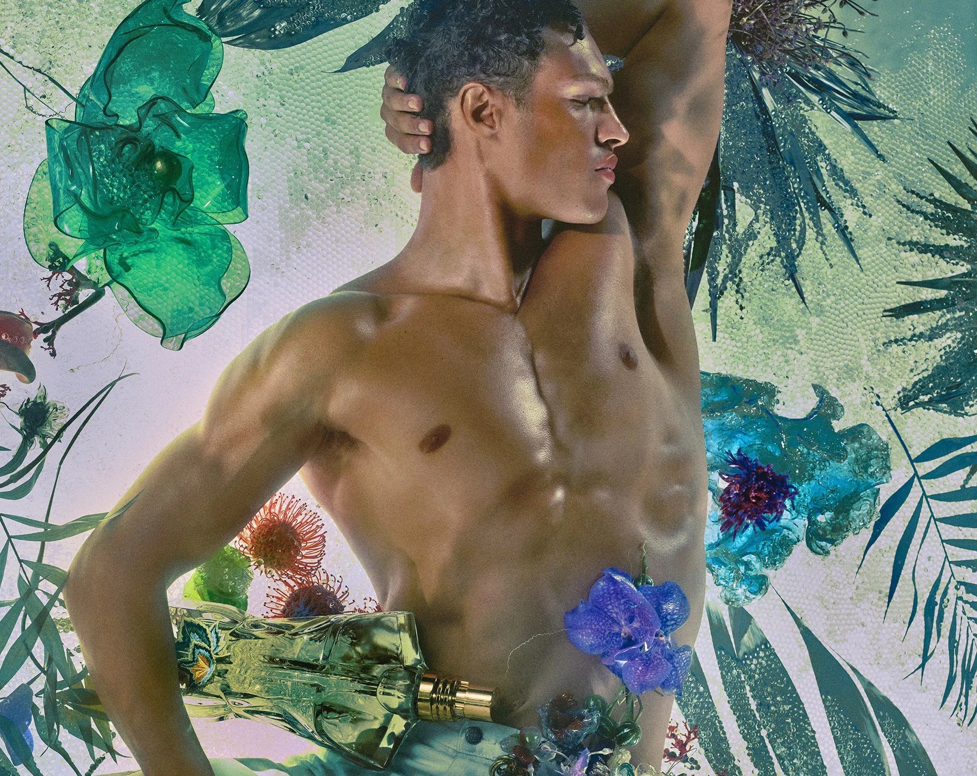 Man with a muscular build against a colorful floral and leaf pattern