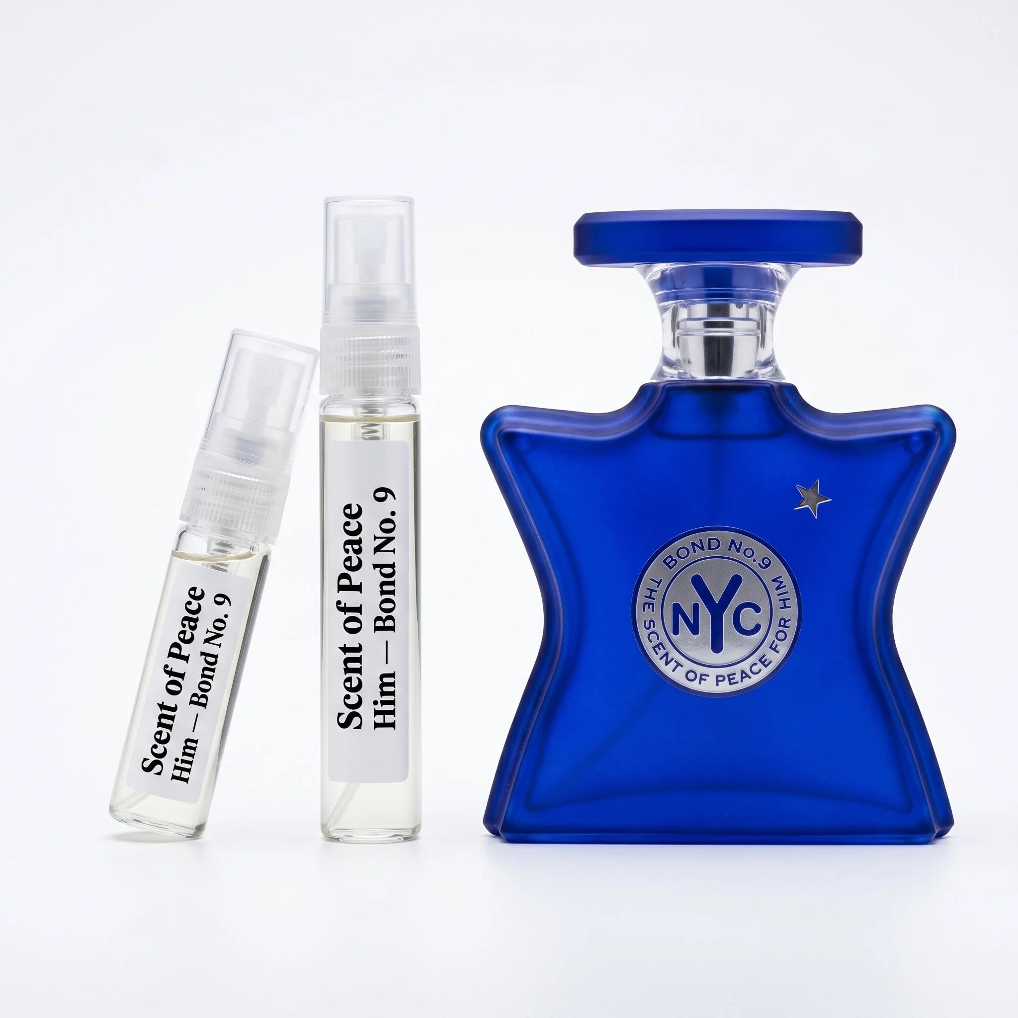 Bond No 9 Scent of Peace for Him decant vials with cobalt blue bottle on white background luxury fragrance photography