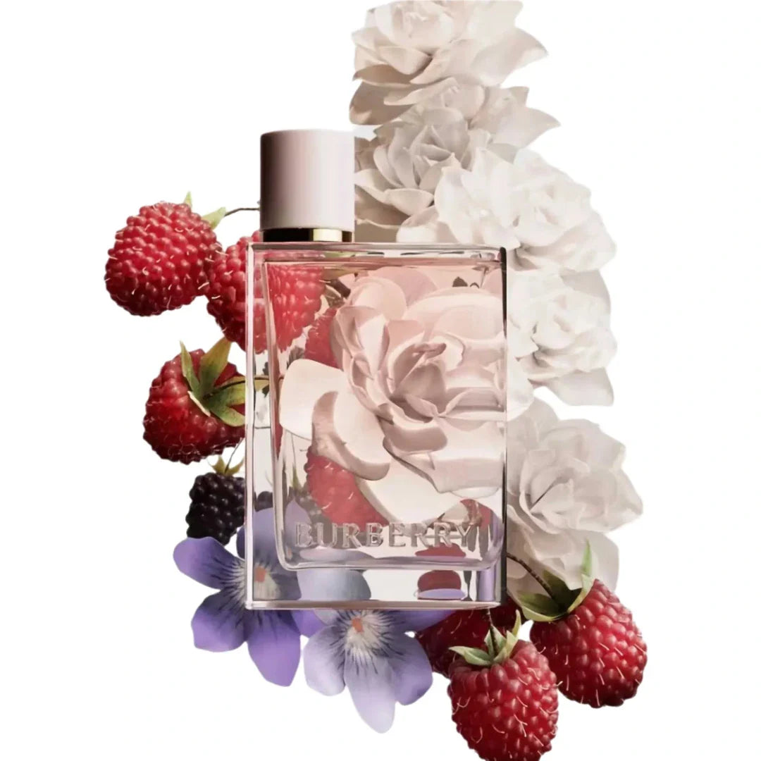 Perfume bottle with floral and berry design on a white background