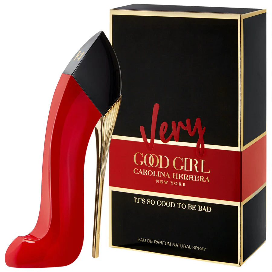 Red high-heeled shoe-shaped perfume bottle with 'Very Good Girl' packaging by Carolina Herrera on a white background.