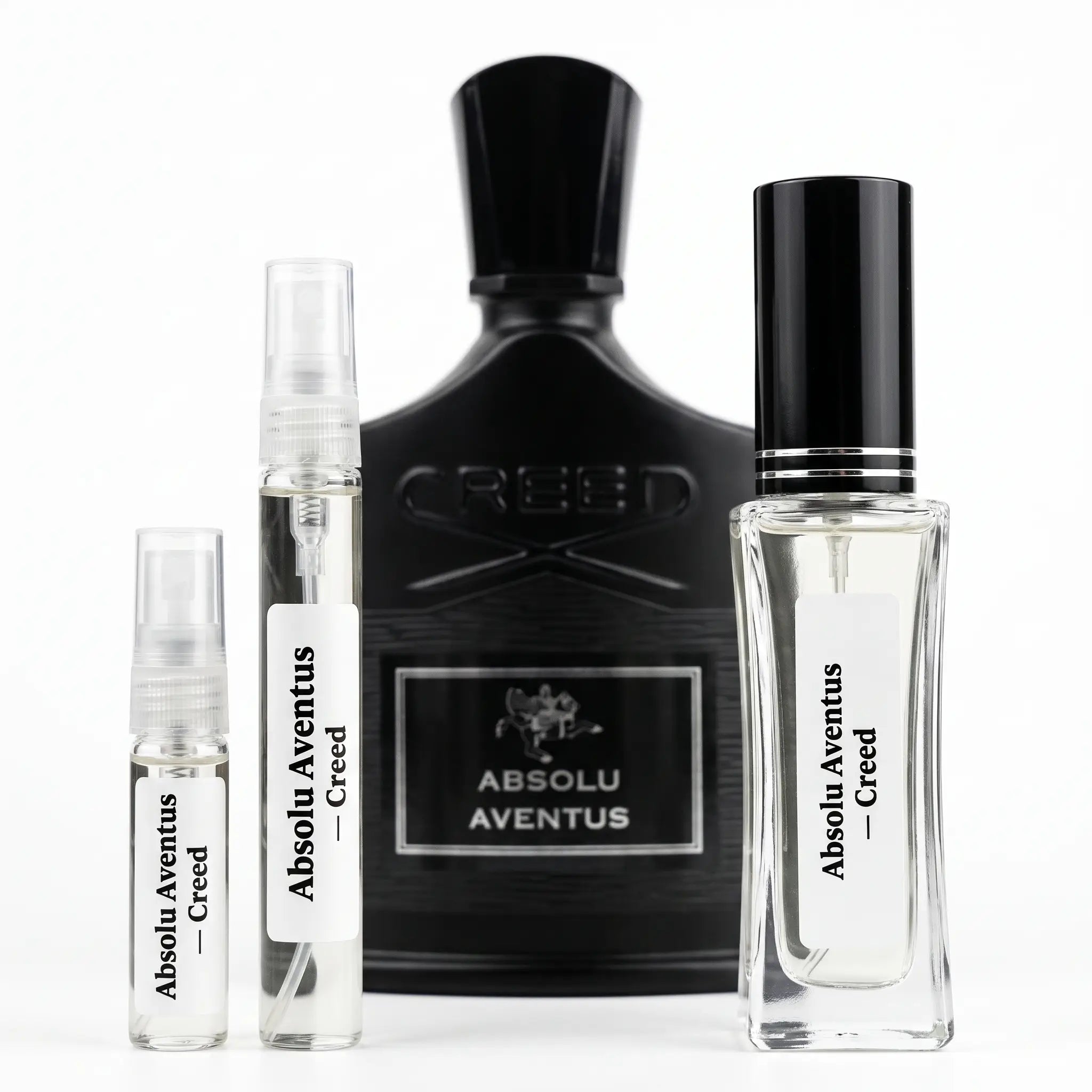 Creed Absolu Aventus fragrance set including a large black bottle, a clear spray vial, a clear atomizer vial, and a clear rectangular perfume bottle with a black cap, all on a white background.