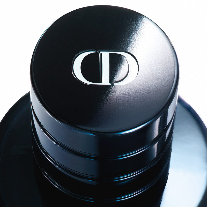 Black perfume bottle cap with Dior logo on a white background