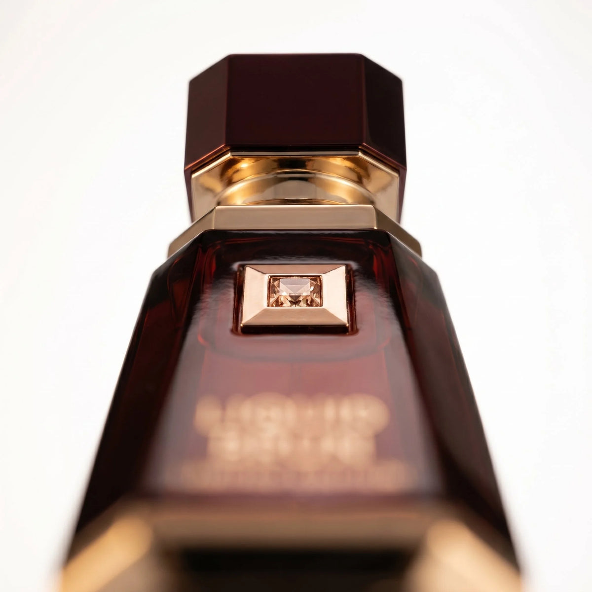 French Avenue Liquid Brun Limited Edition rose gold gemstone detail close up dark burgundy bottle luxury fragrance photography