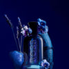 BOSS perfume bottle with flowers on a dark background