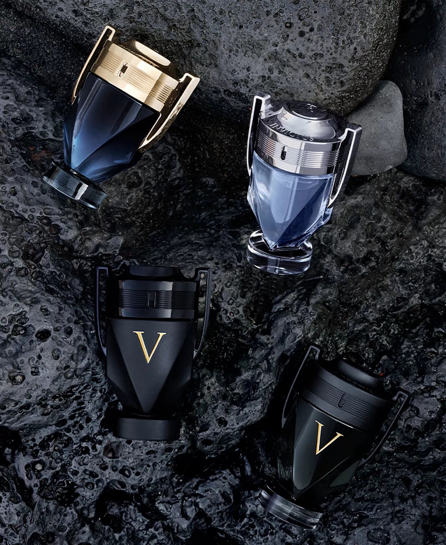 Collection of perfume bottles on a dark stone surface