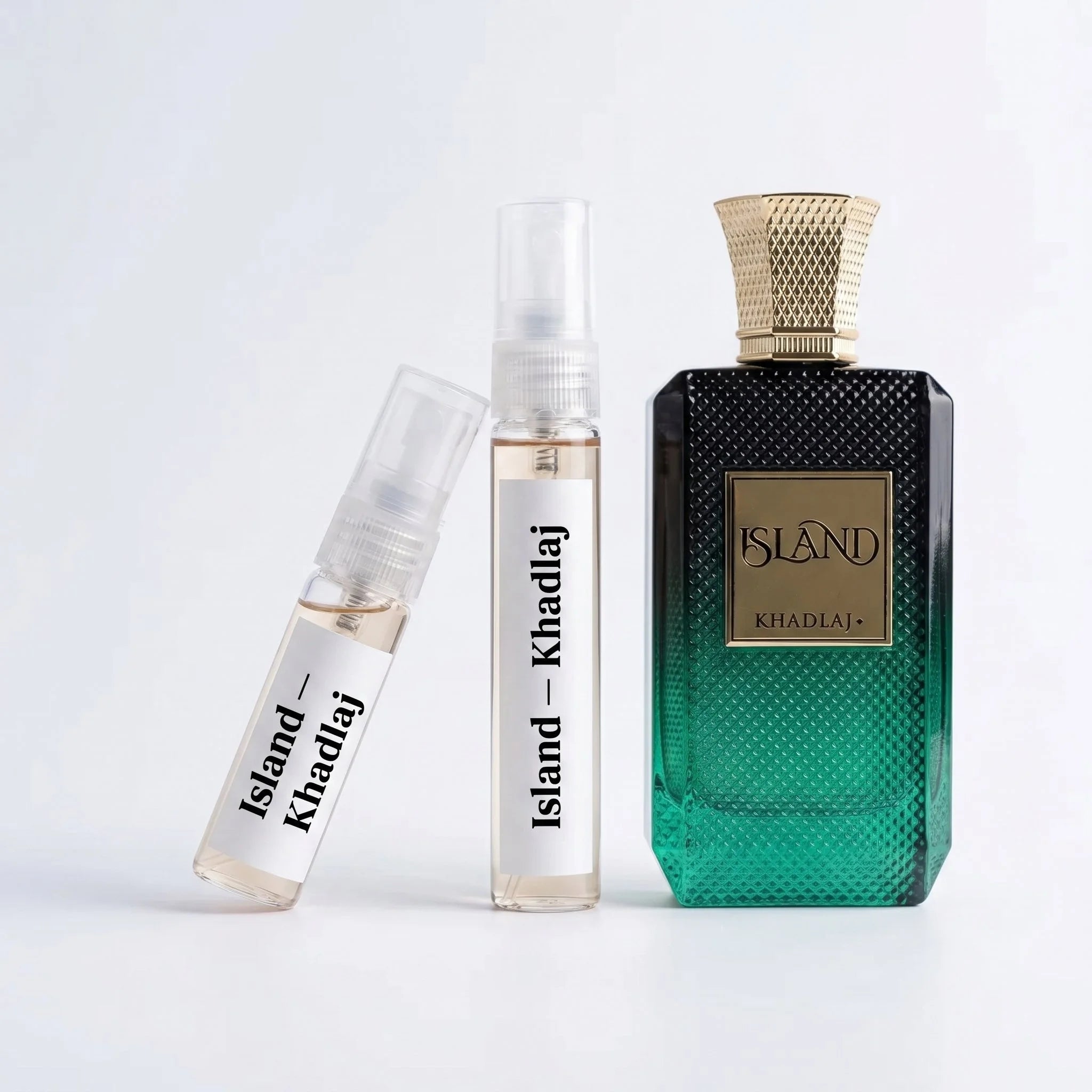Khadlaj Island decant vials with emerald green diamond textured bottle on white background luxury fragrance photography