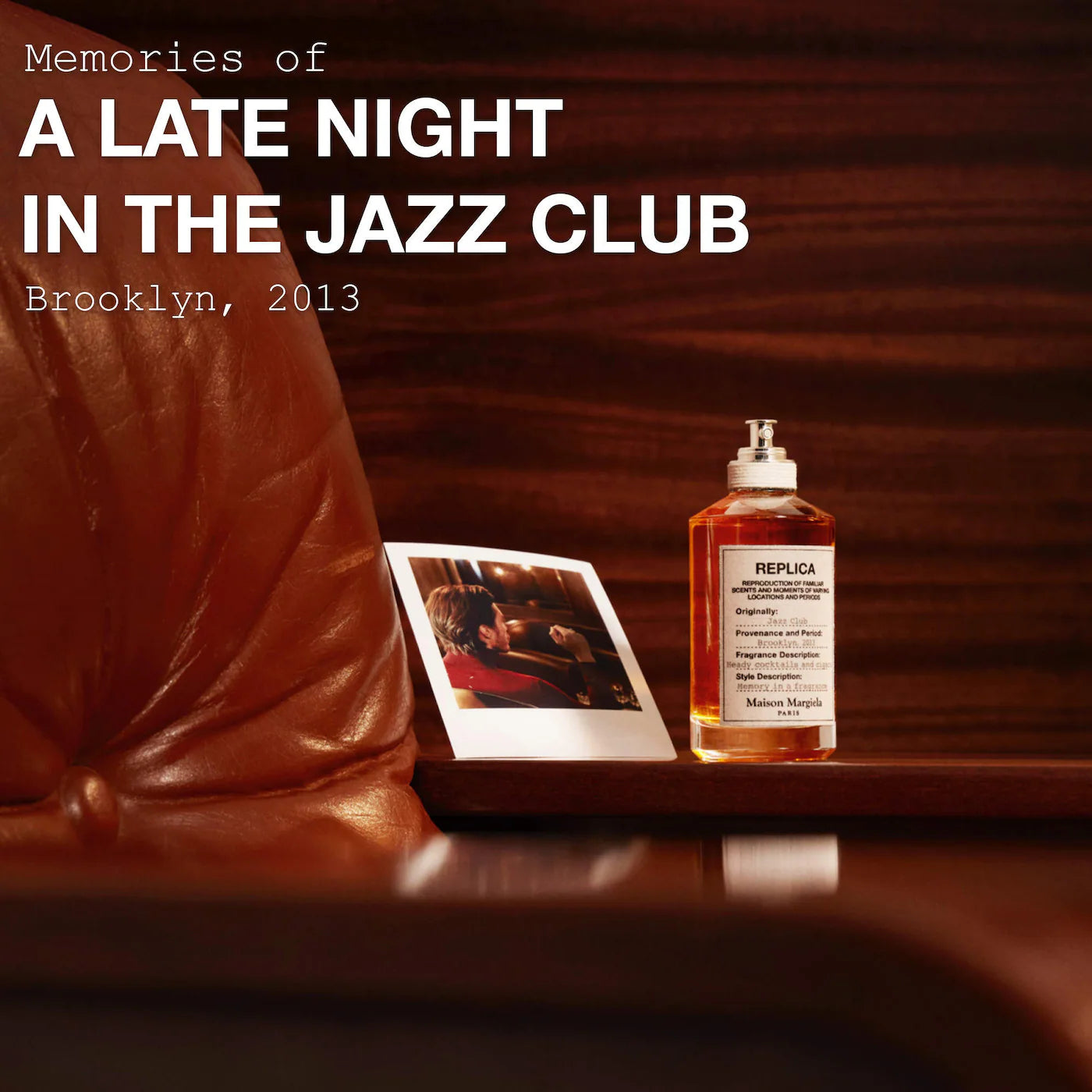 Bottle of replica cologne with a Polaroid photo on a leather couch, evoking memories of a late night in a jazz club.