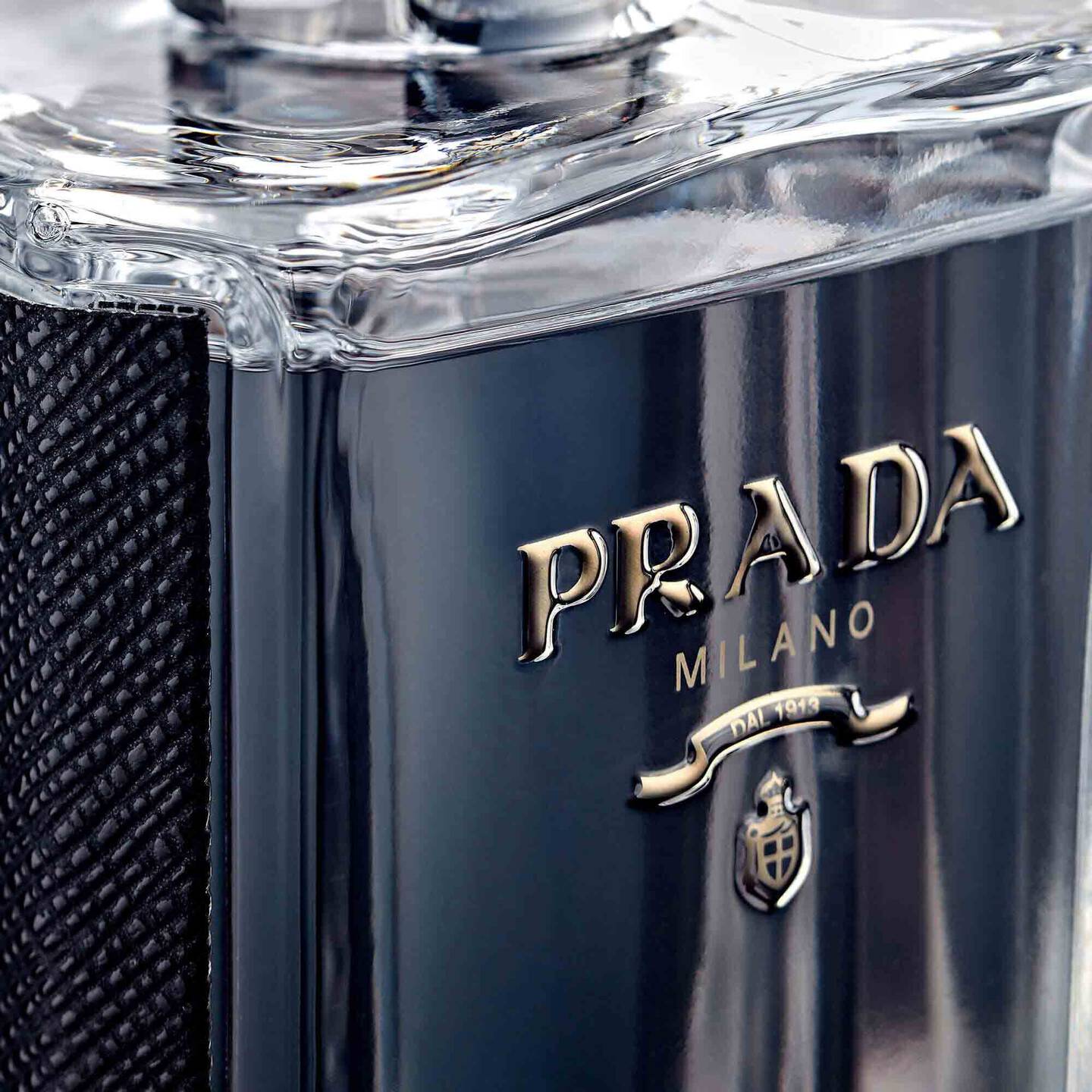 Close-up of a Prada Milano perfume bottle with clear cap