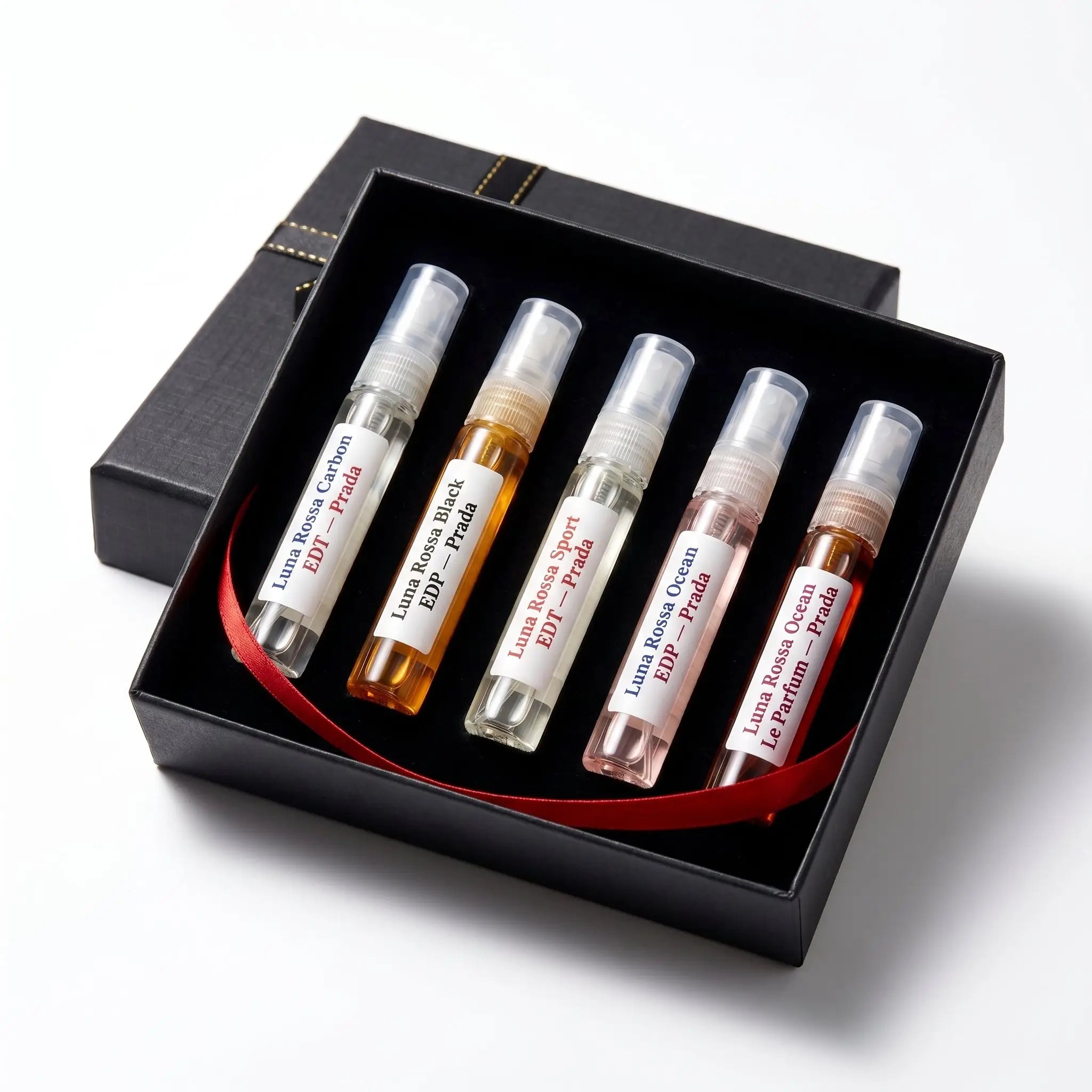 Prada Luna Rossa Discovery Set decants in open gift box with red ribbon — five Luna Rossa fragrances
