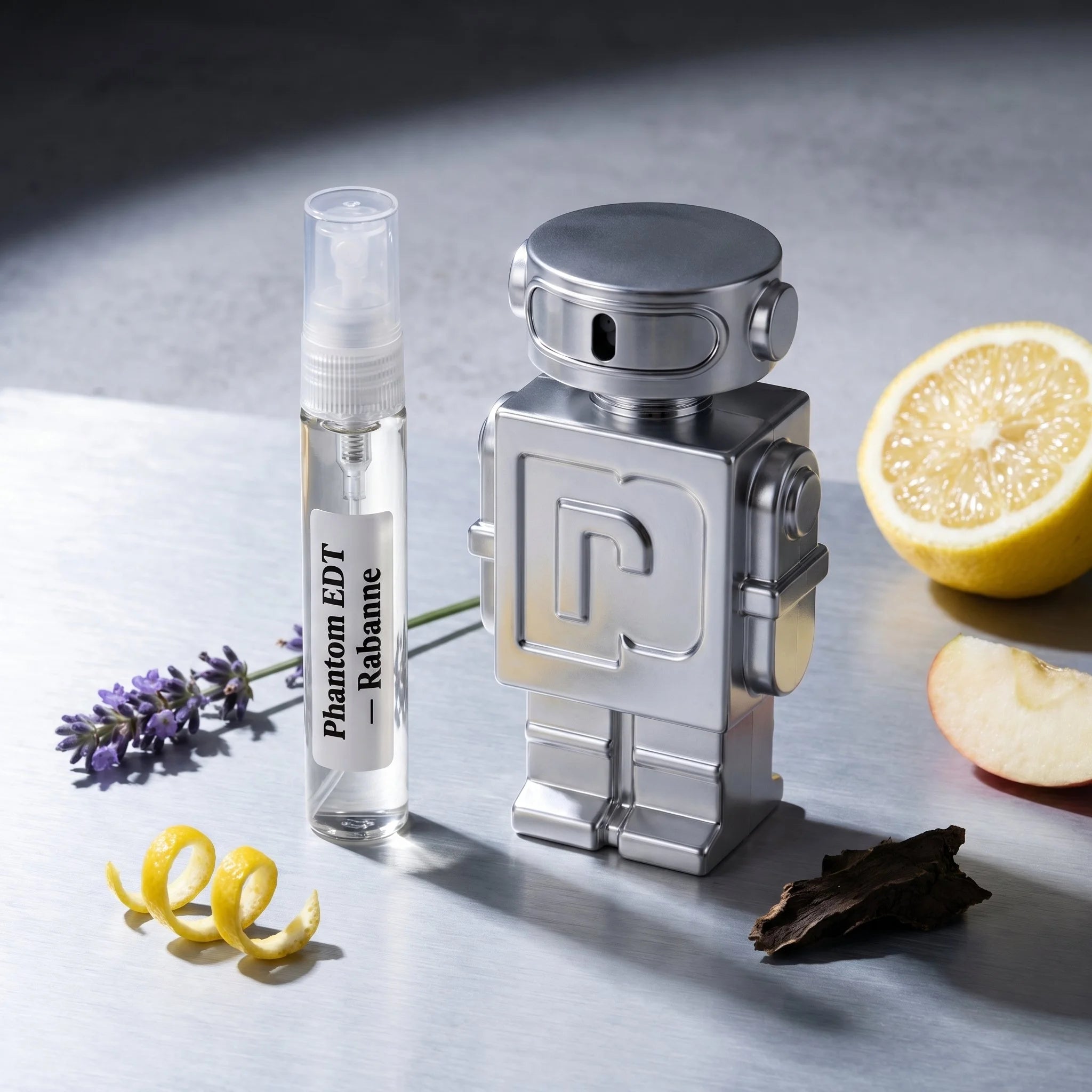 Rabanne Phantom EDT bottle and decant on grey concrete with lavender lemon apple patchouli vanilla vetiver fragrance notes flatlay