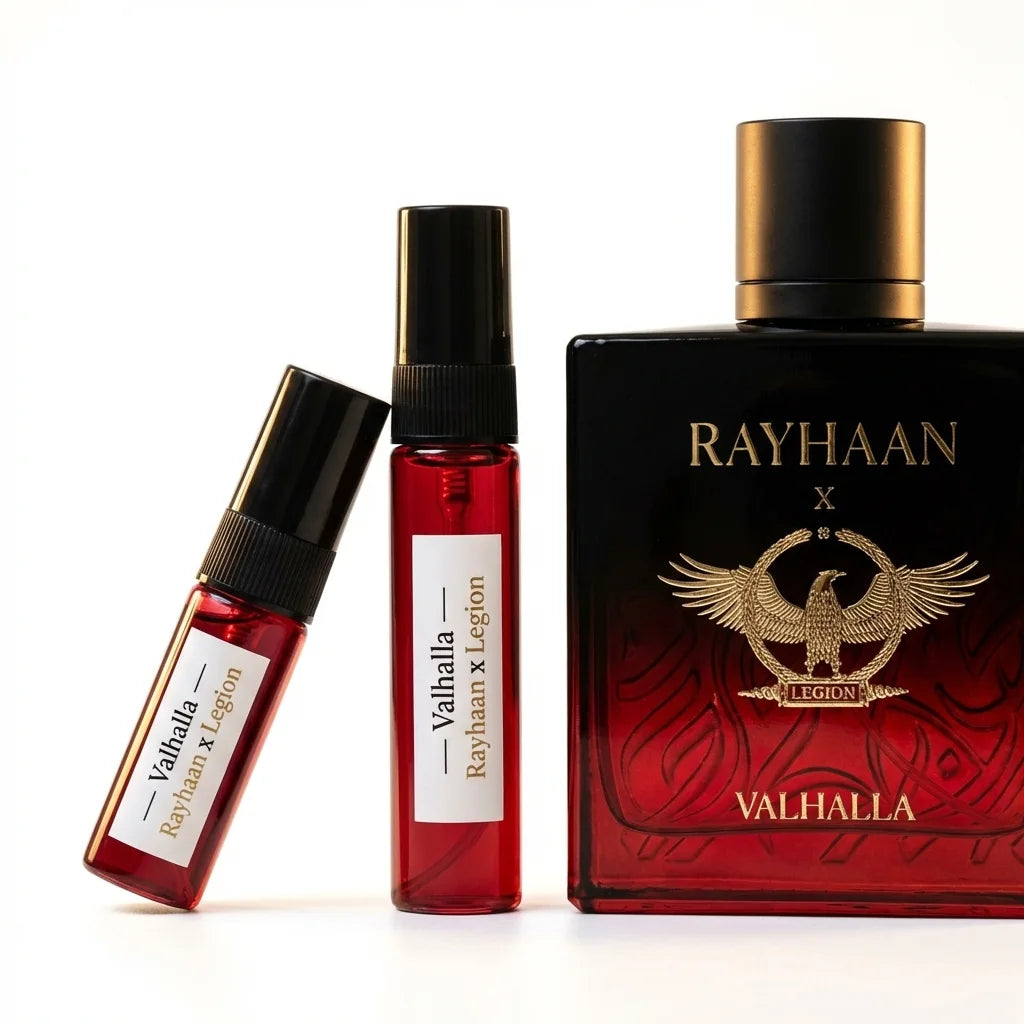 Two red perfume bottles with black caps and a larger black bottle labeled 'RAYHAAN x VALHALLA' on a white background.