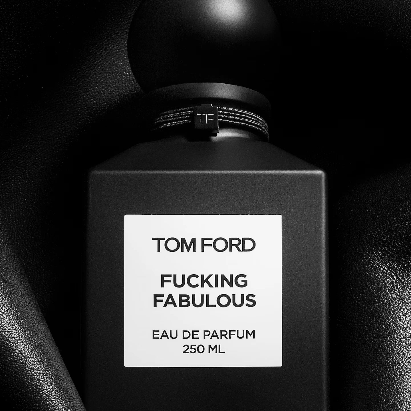 Black Tom Ford perfume bottle with 'Fucking Fabulous' label on a dark background