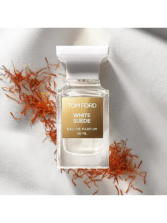 Tom Ford White Suede perfume bottle with saffron on a light background