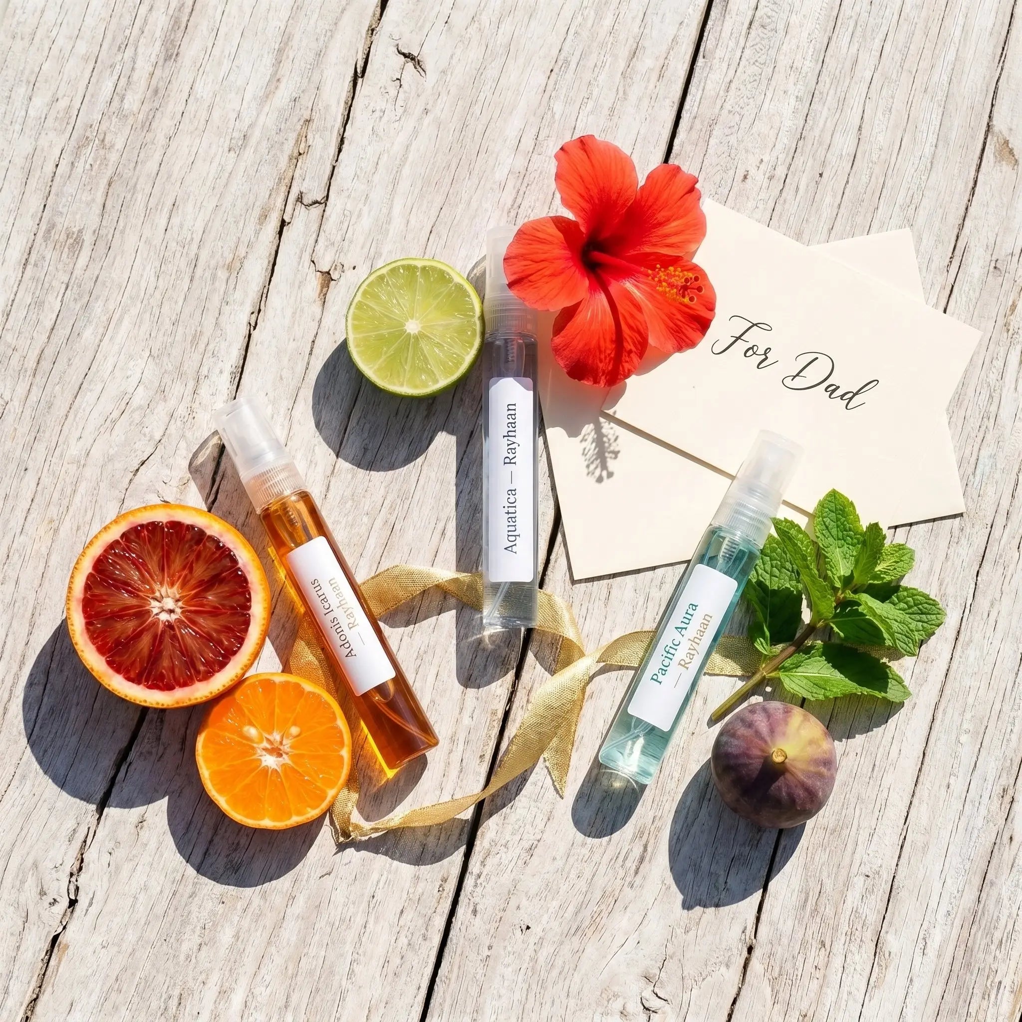 Vacation Mode outdoor flatlay β Rayhaan decants with blood orange, lime, hibiscus and fig on driftwood