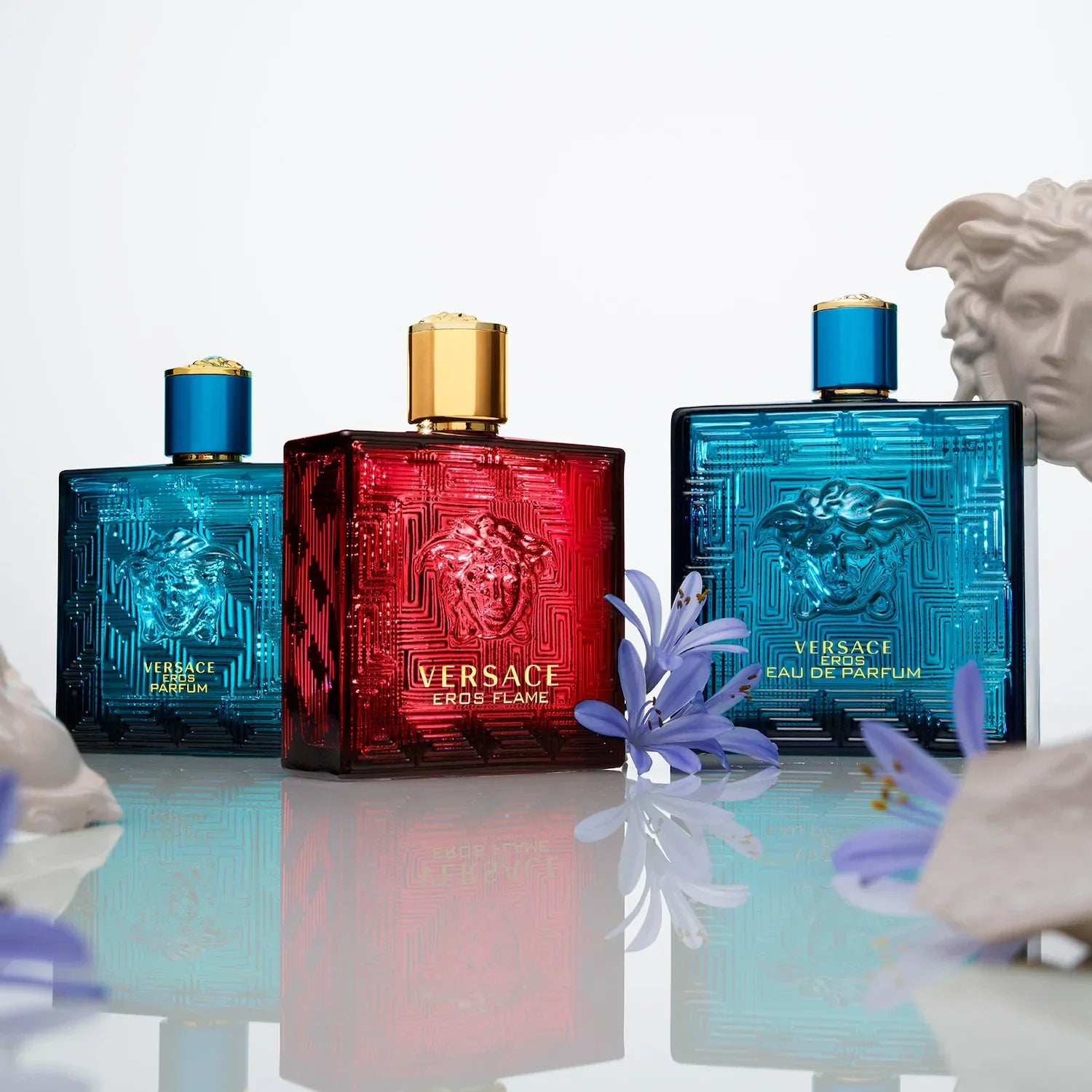 Versace Eros Flame collection featuring authentic designer fragrances in red and blue bottles with Greek key pattern design