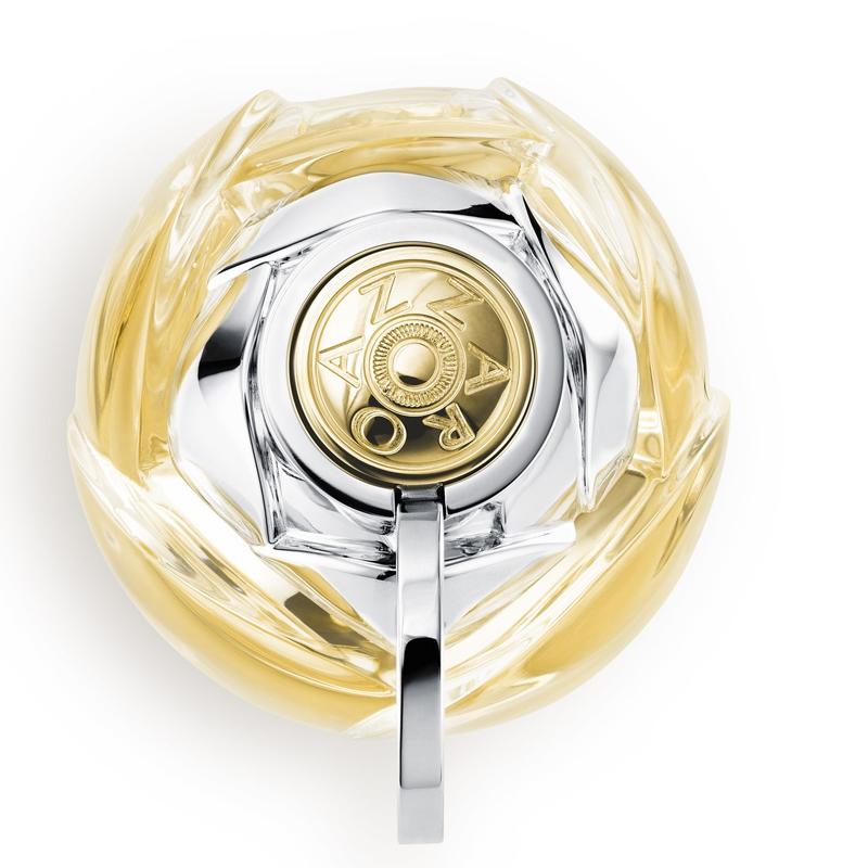 Gold and silver circular object with intricate design on a white background