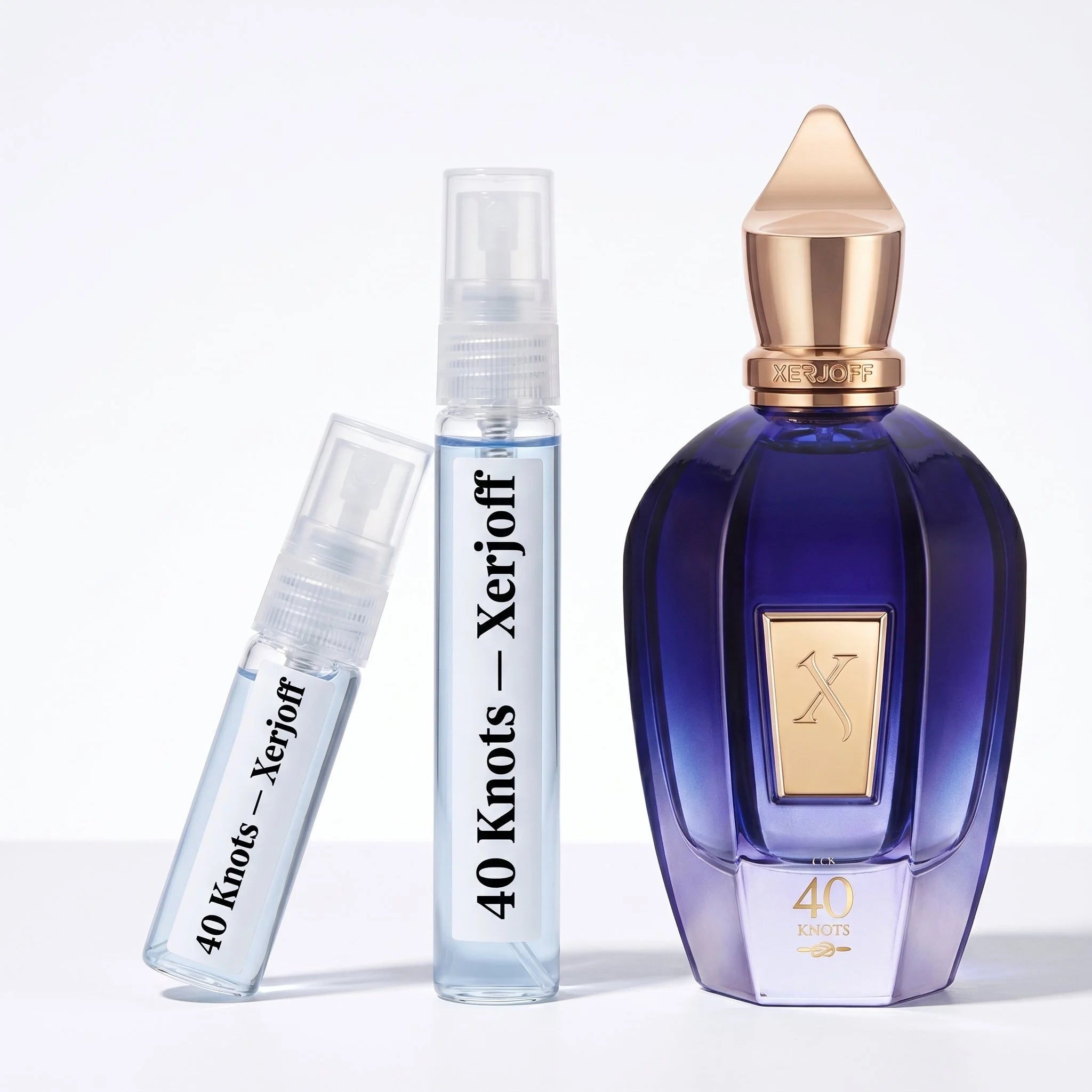 Xerjoff 40 Knots decant vials with indigo blue bottle on white background luxury niche fragrance photography
