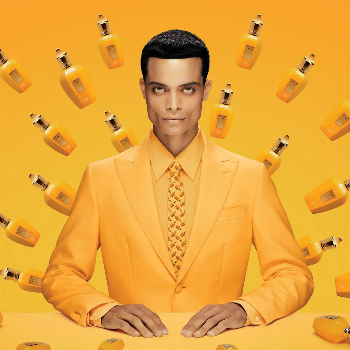 Man in a yellow suit with matching products on a yellow background