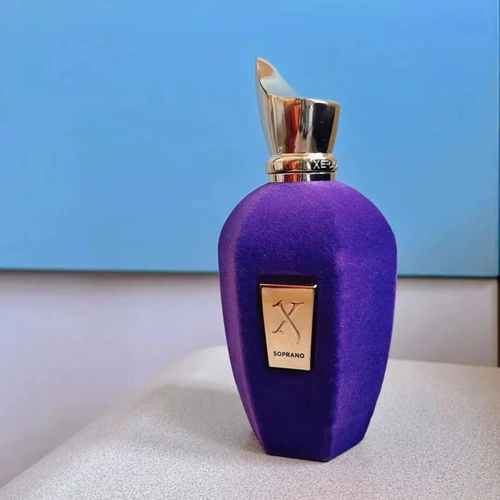 Purple perfume bottle with gold cap on a light blue background