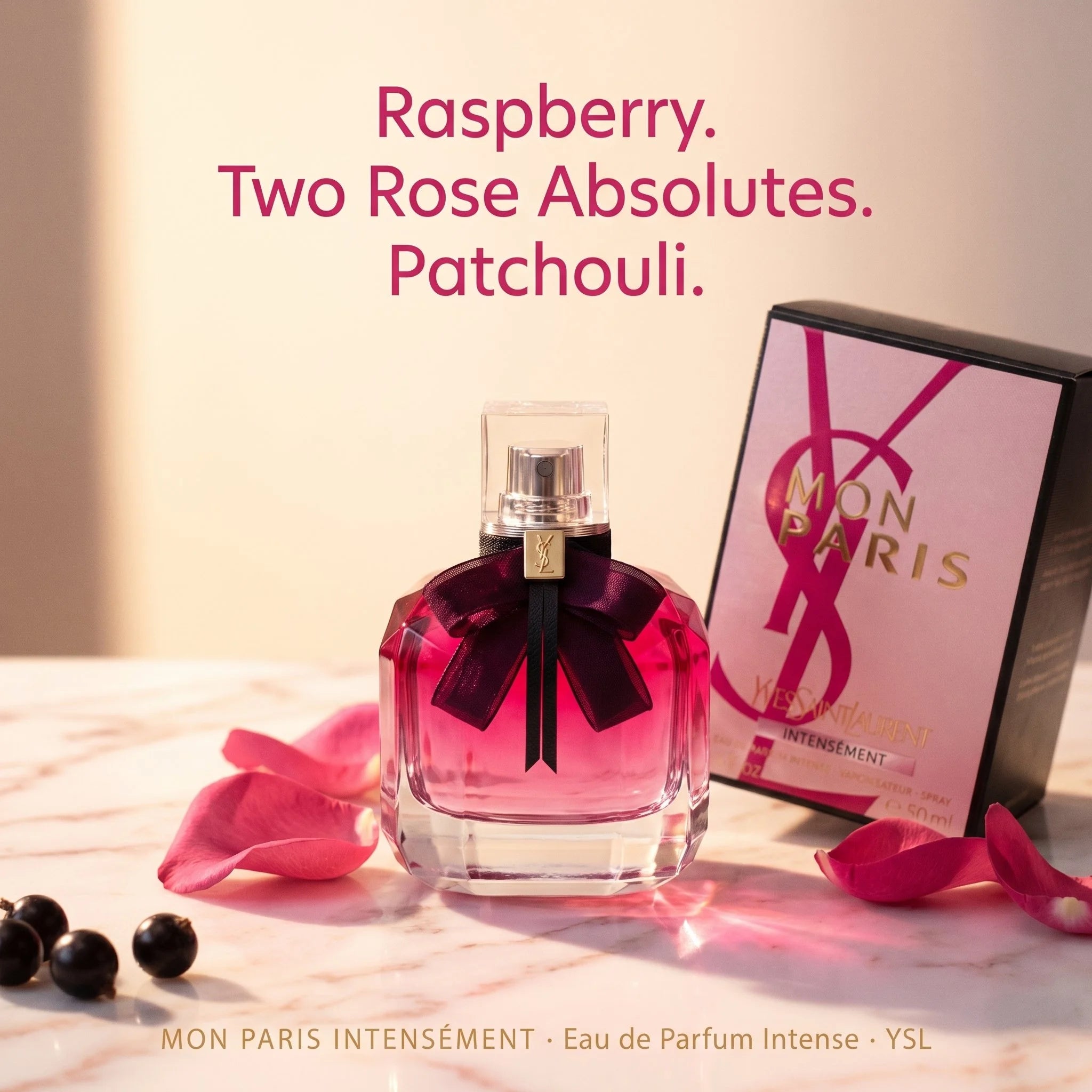 YSL Mon Paris Intense perfume bottle with packaging on a light surface with pink petals and berries.