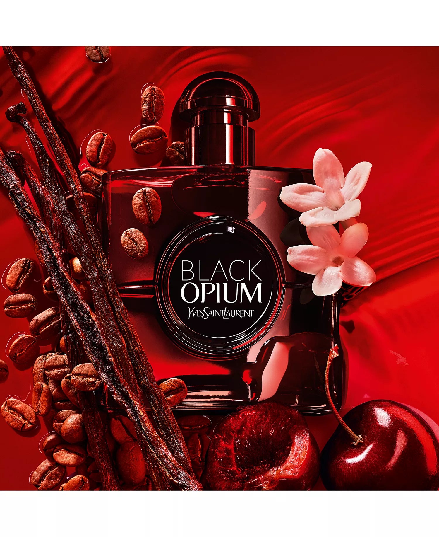 Yves Saint Laurent Black Opium perfume bottle with coffee beans, vanilla pods, and cherry on a red background