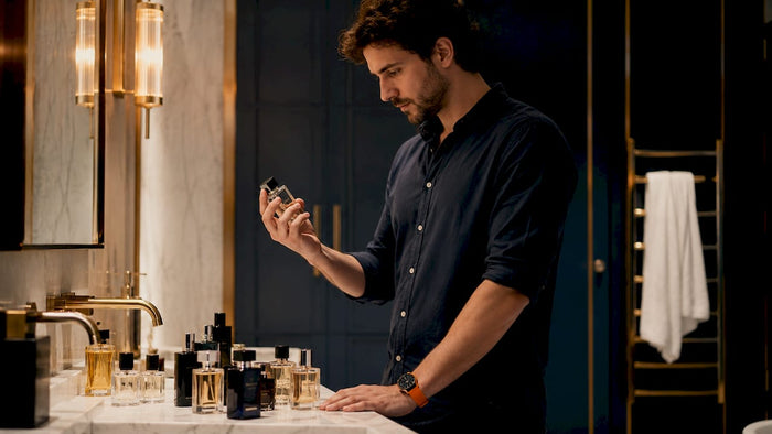 Man selecting men's cologne in walk-in closet
