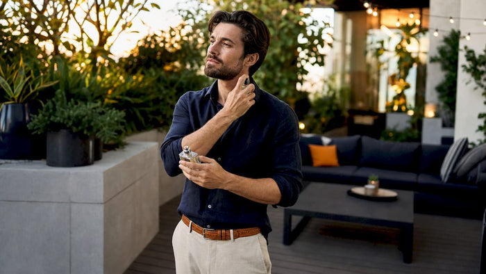 Man applying floral fragrance in modern bathroom