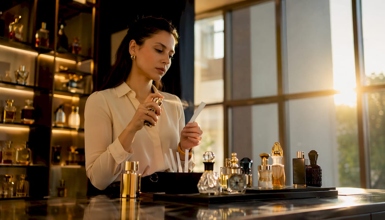 Woman sampling prestige fragrance in boutique