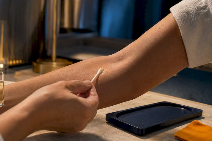 Applying diluted perfume to inner elbow