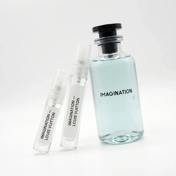 Louis Vuitton Imagination decant vials with clear glass apothecary bottle pale icy aqua blue juice black cap on white background luxury fragrance photography