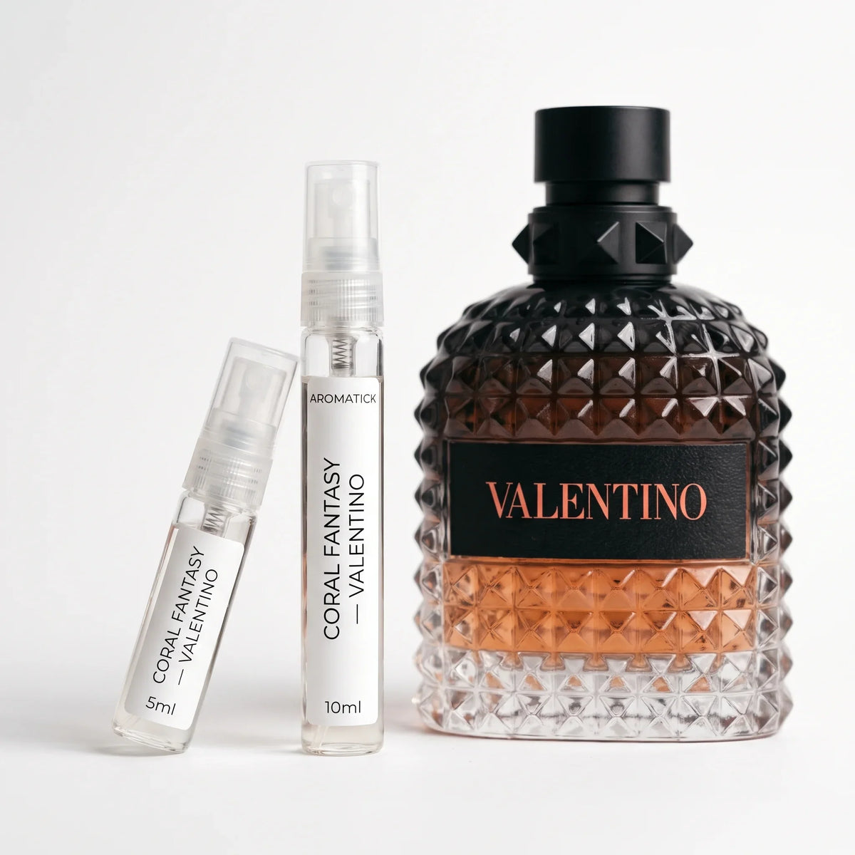 Valentino Born in Roma Coral Fantasy decant 5ml and 10ml atomizers beside the coral studded bottle