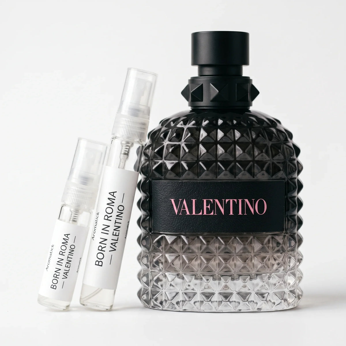 Valentino Uomo Born in Roma EDT decant 5ml and 10ml atomizers beside the studded black bottle