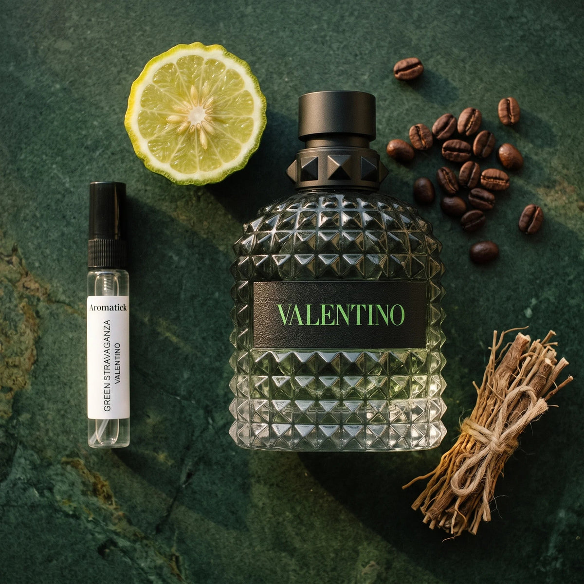 Valentino Green Stravaganza flatlay with bergamot, roasted coffee beans and vetiver roots