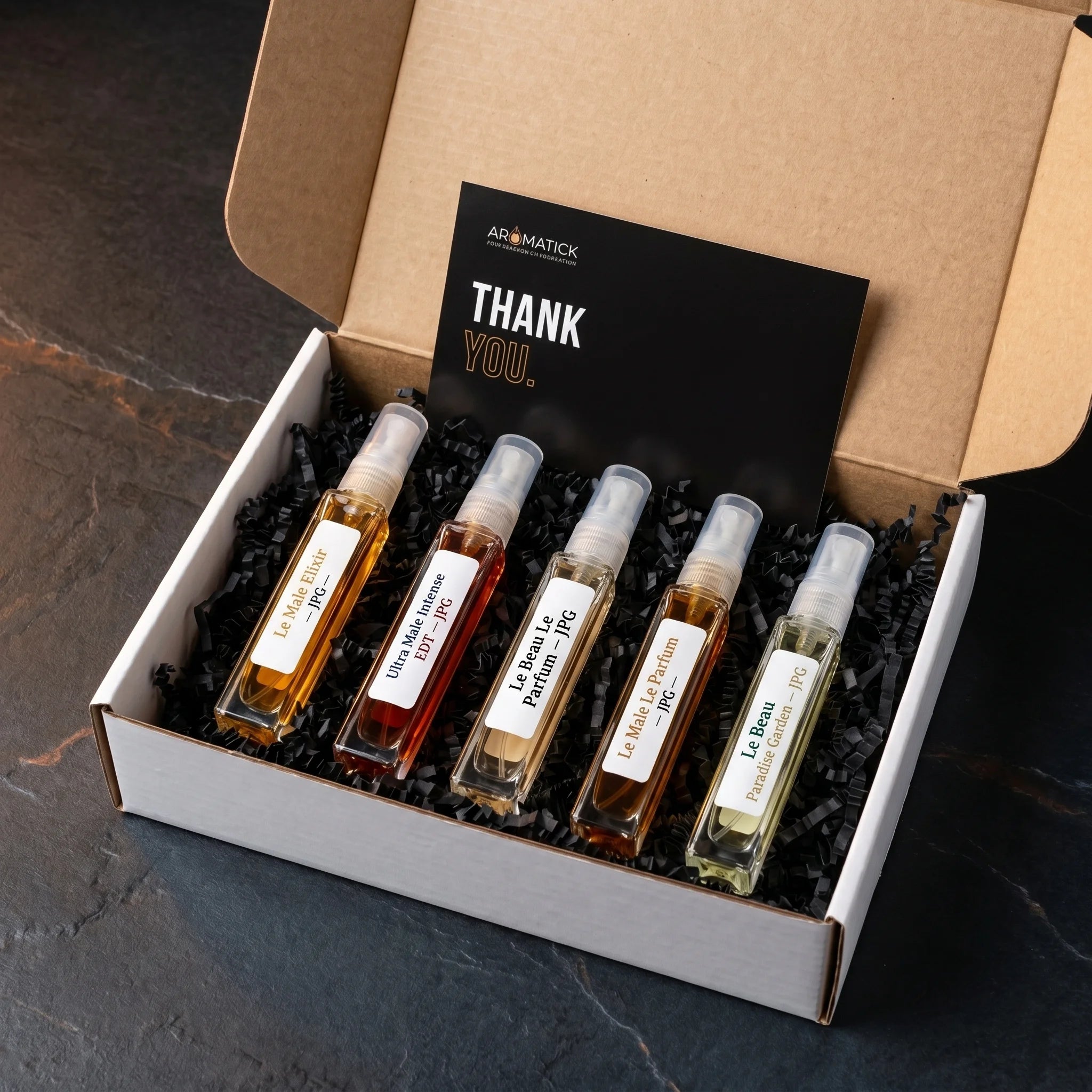 Aromatick Le Male & Le Beau Discovery Set unboxing — five Jean Paul Gaultier 5ml decants of Le Male Elixir, Ultra Male Intense, Le Beau Le Parfum, Le Male Le Parfum, and Le Beau Paradise Garden in the kraft mailer with the Aromatick thank-you card