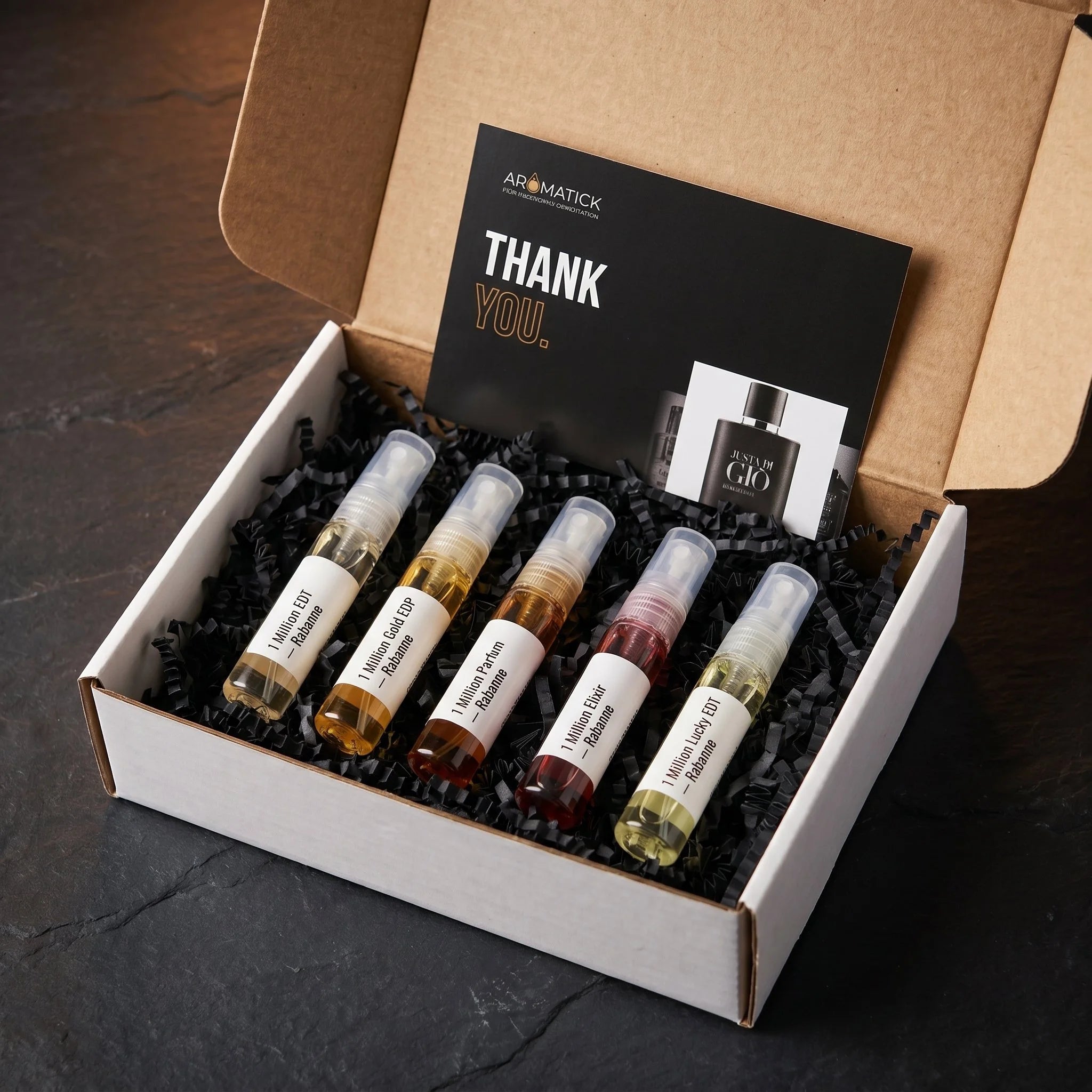 Aromatick 1 Million discovery set unboxing — five Rabanne decants in white gift box with black crinkle paper and thank you card